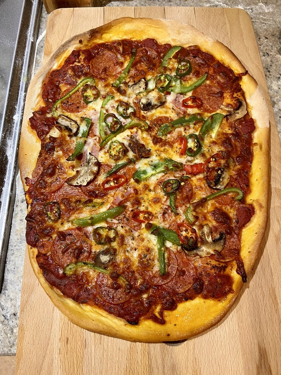 A pepperoni, pepper, mushroom and chilli pizza