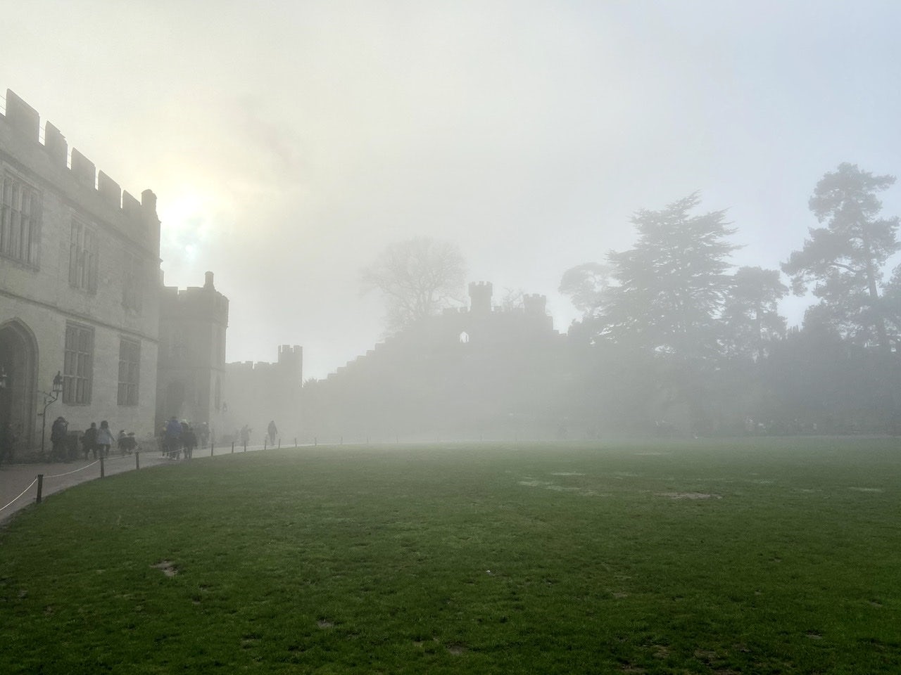 A foggy castle courtyard and lawn