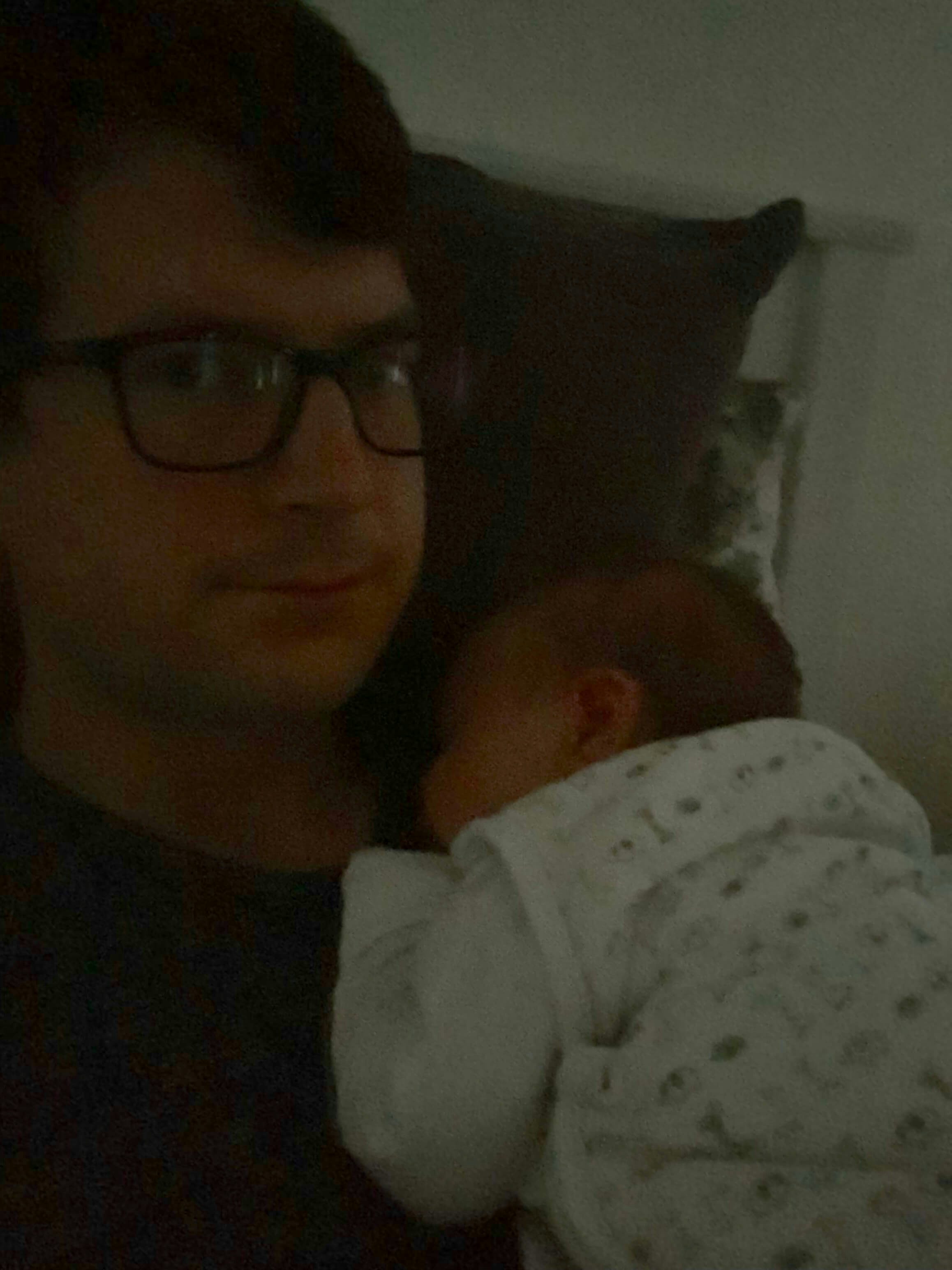 A baby asleep on her dad’s chest