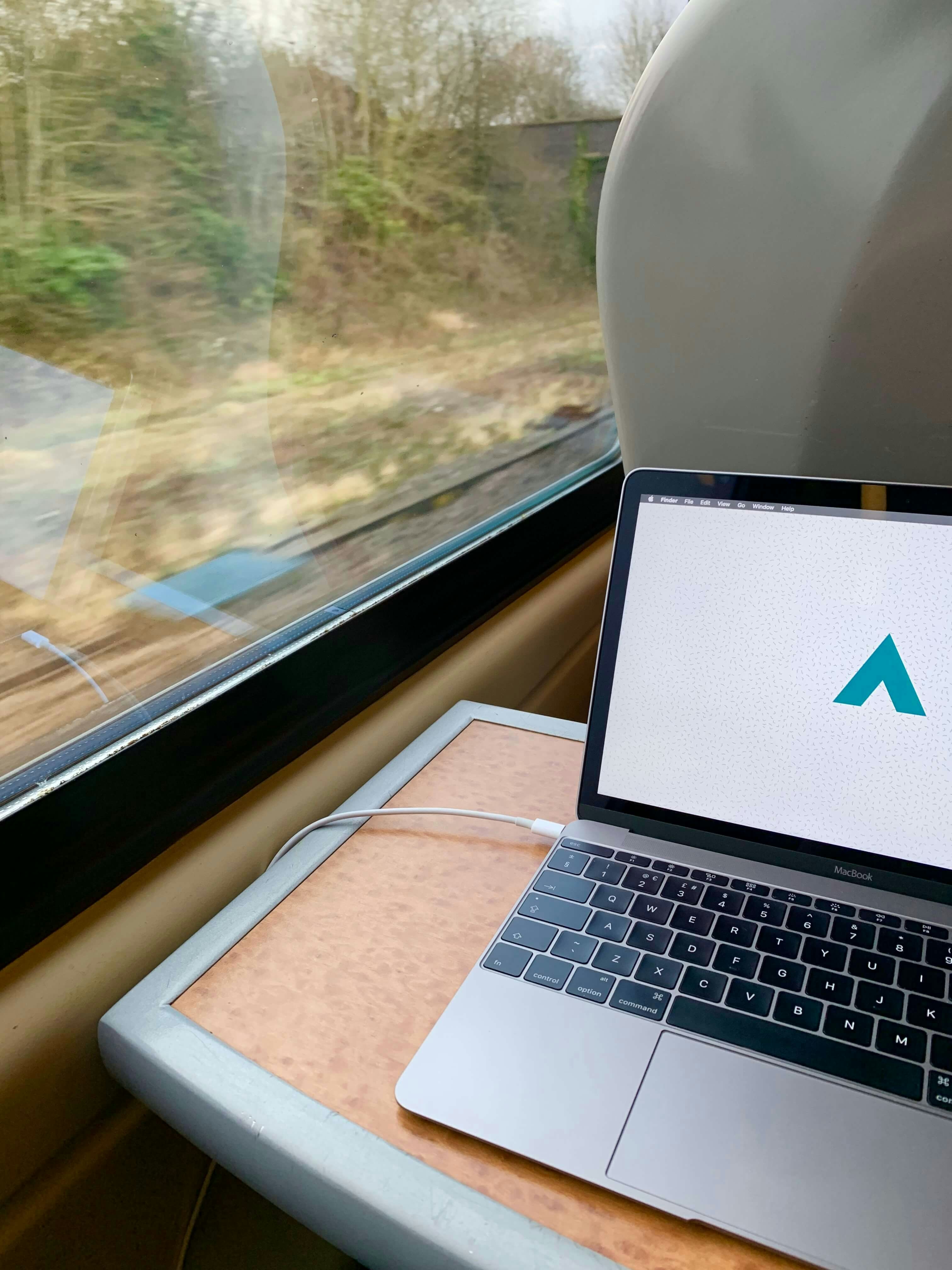 A laptop on a table inside a train