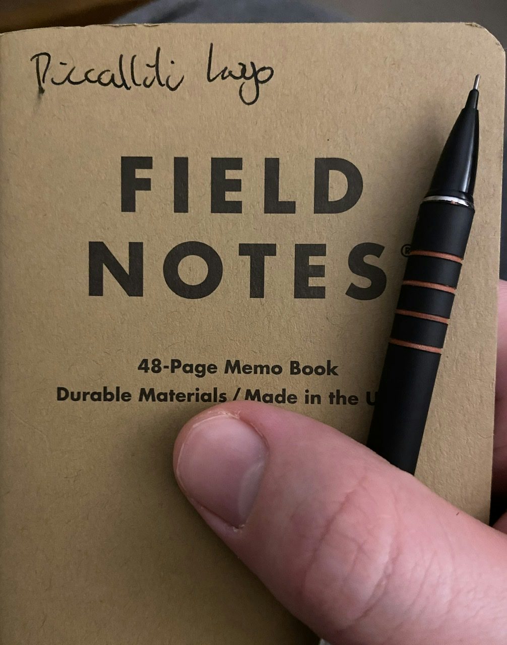 Field Notes notebook with "piccalilli logo" written on it with black ink